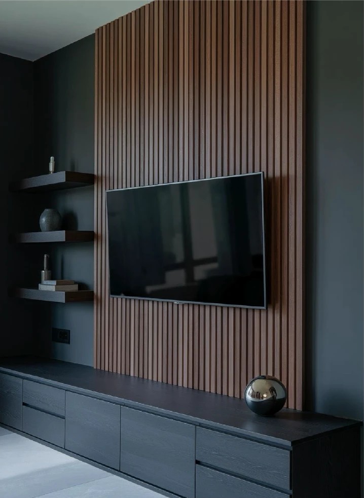 Wood slat media wall with TV and floating shelves